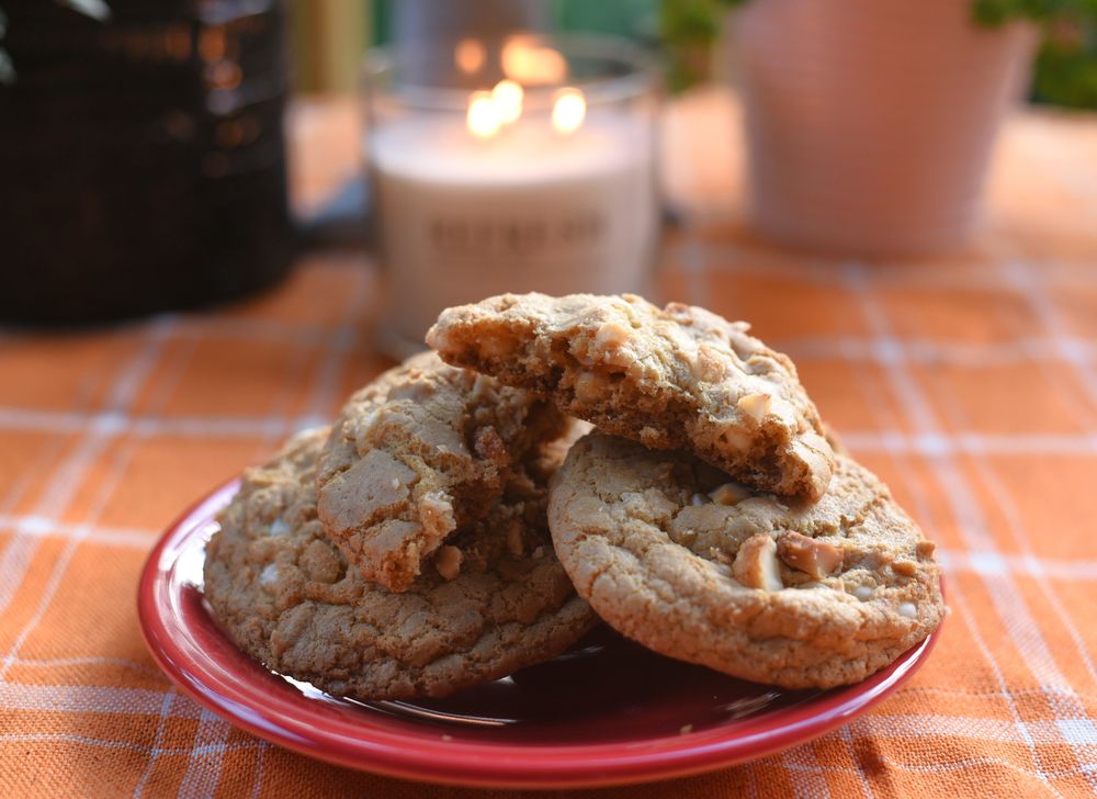 A cookie broken open on a plate, its filling just out of view