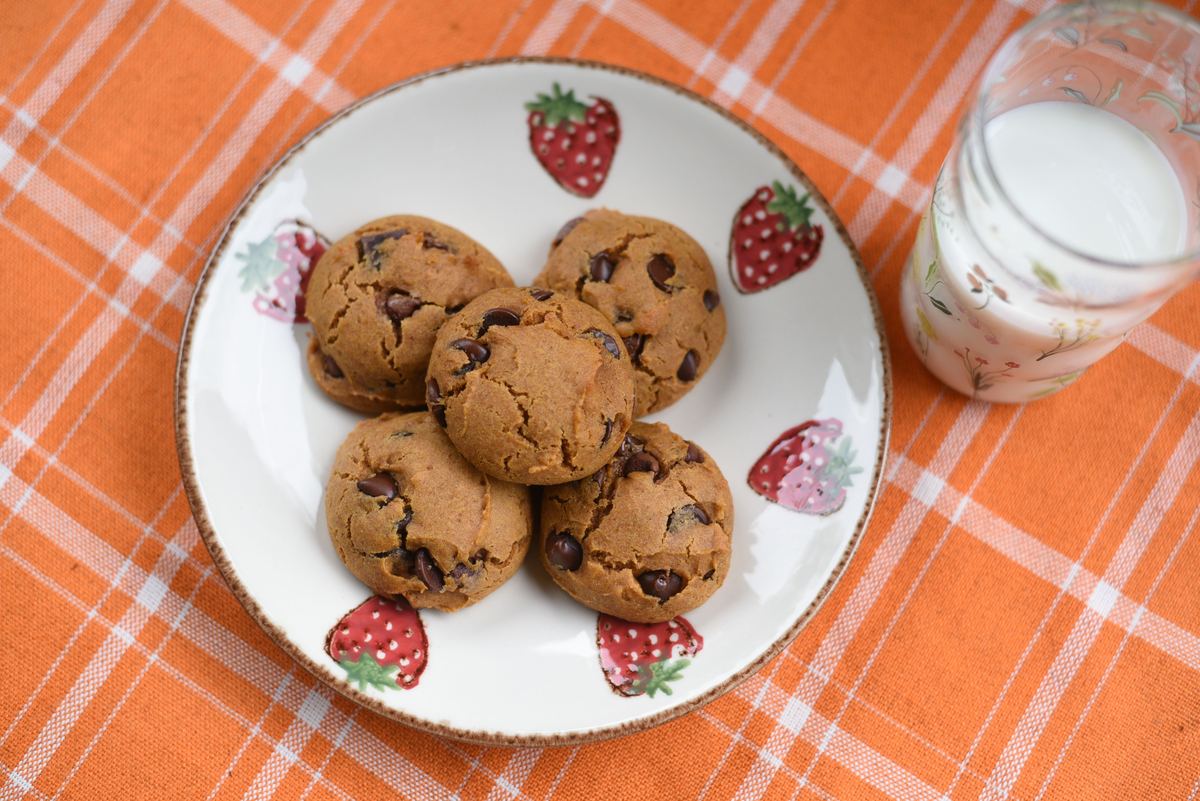 Pumpkin chocolate chip cookies with a glass of milk