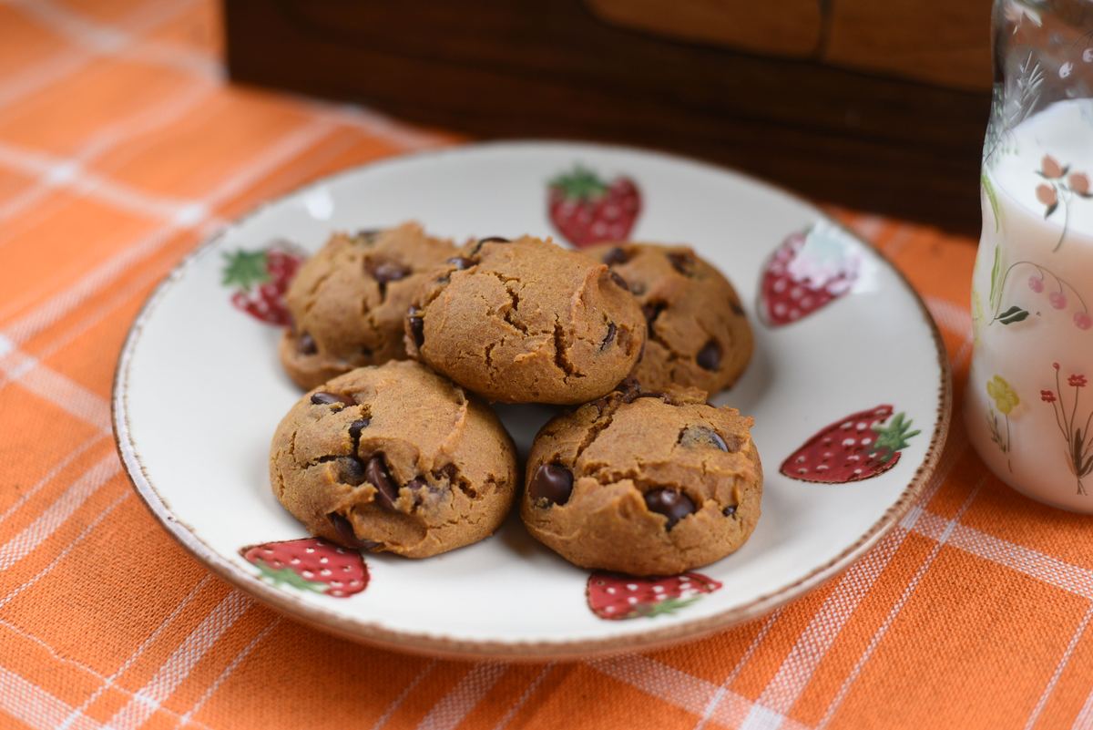 Pumpkin chocolate chip cookies stacked on a strawberry plate